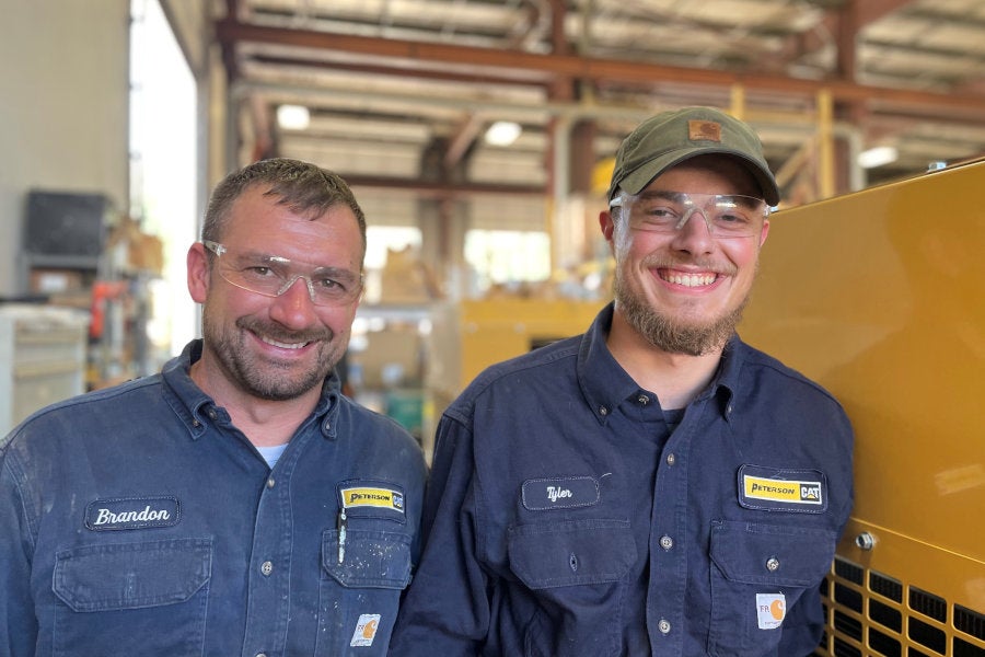 Two Peterson Power shop technicians smiling in the Hillsboro, Oregon shop